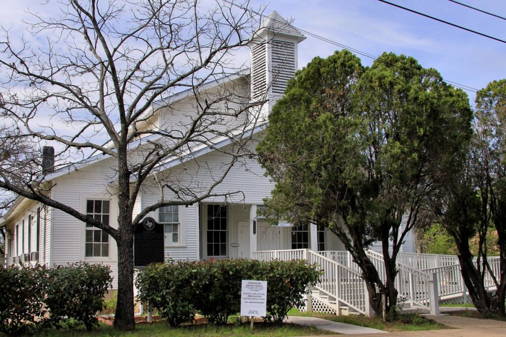The white wooden Sweet Home Baptist Church with a small steeple and a porch ramp in the Clarksville neighborhood of Austin