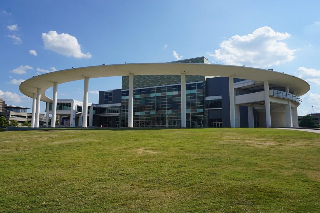 The Long Center for the Performing Arts in Austin, with its ring of white columns and glass facade above a grassy lawn