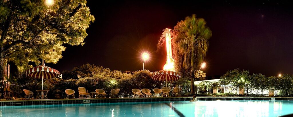 The Austin Motel's pool lit up at night on South Congress, one of the classic answers to where to stay in Austin