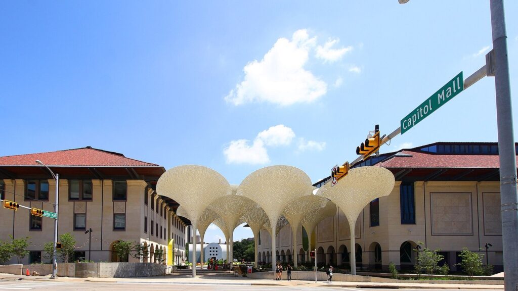 The Blanton Museum of Art's white petal-shaped canopies and red-roofed buildings on the Capitol Mall at the University of Texas