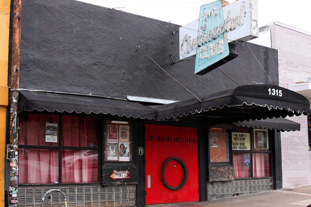 The Continental Club on South Congress with its black awning, neon sign and red doors