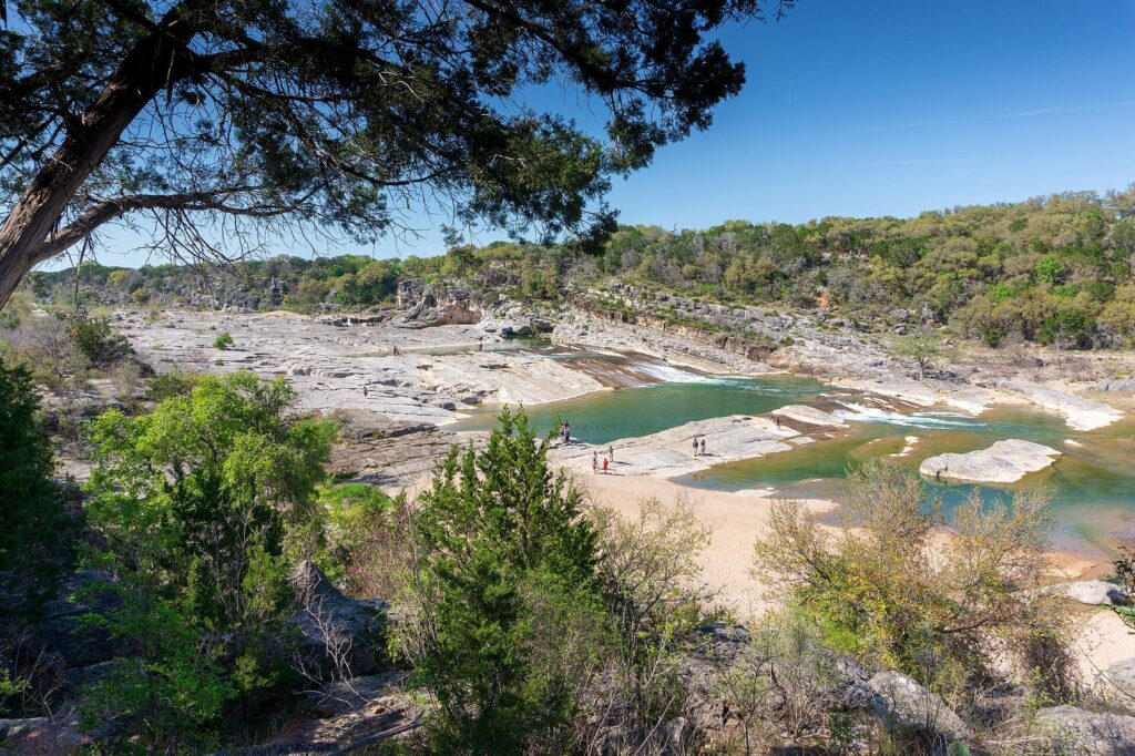 The wide limestone ledges and green pools of the Pedernales River seen from the overlook, one of the easiest day trips from Austin