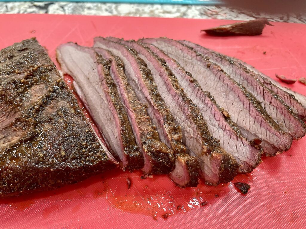 Sliced smoked brisket with a deep pink smoke ring, the dish that anchors most lists of the best restaurants in Austin